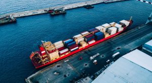 Aerial top view of industrial cargo container logistics ship in terminal in Italy